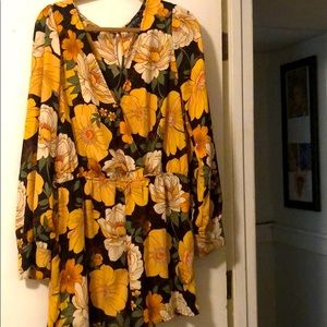 An orange and green deep v-neck floral romper.